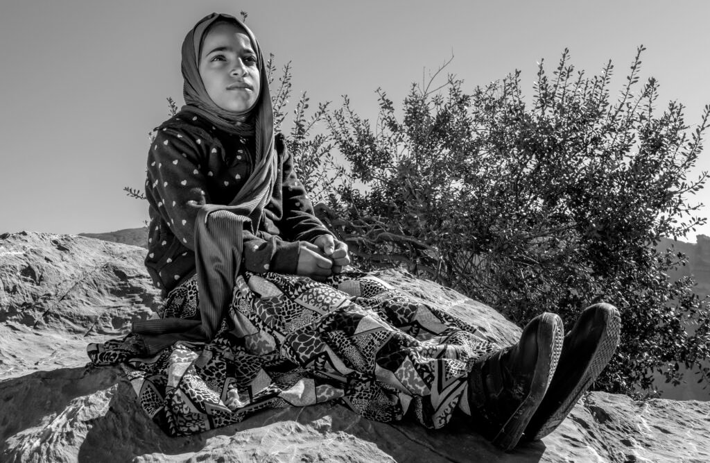 Black and white portrait seated outdoors