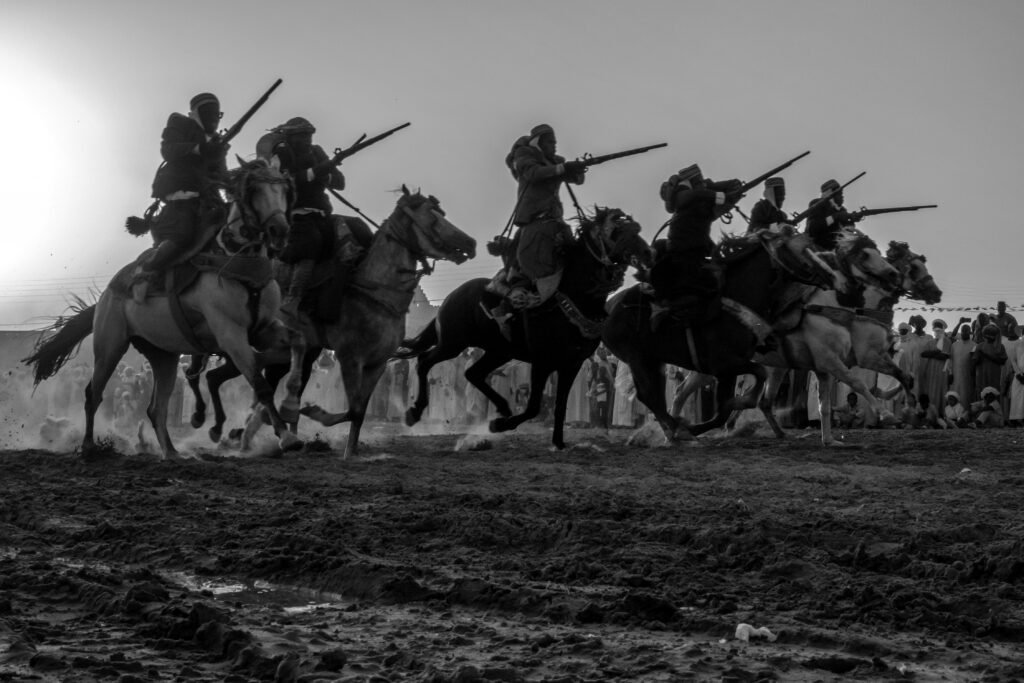 Horse riders moving through dust