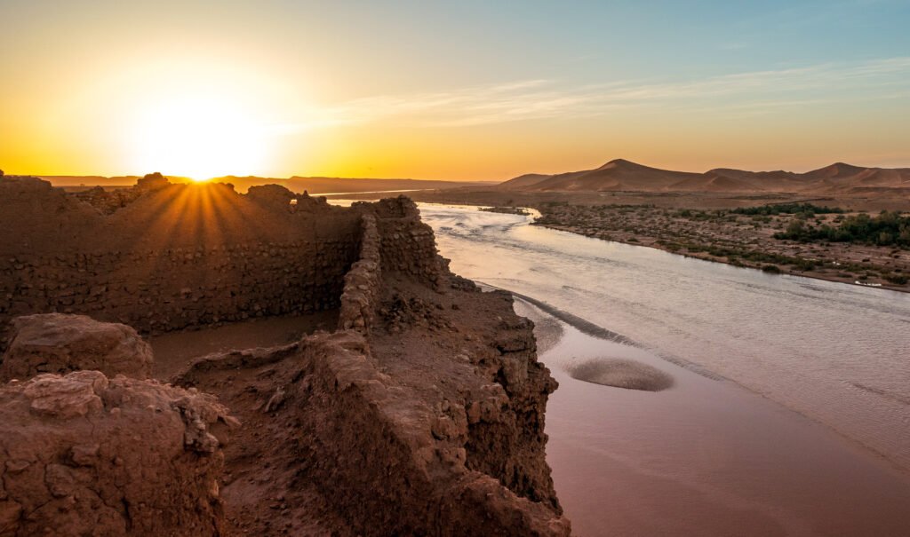 Sun setting over a desert river valley