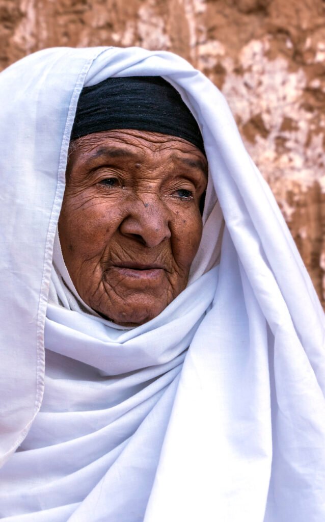 Close portrait of an elderly woman in white attire